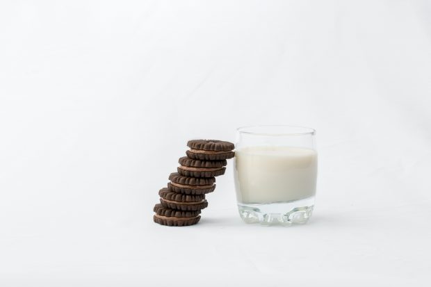 Decorative only - 4 cookies leaning against a glass of milk