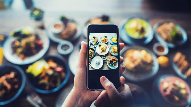 Hand holding phone over food for Citizen Science Blog