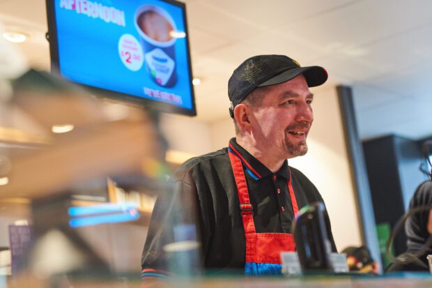 Greggs employee in a store