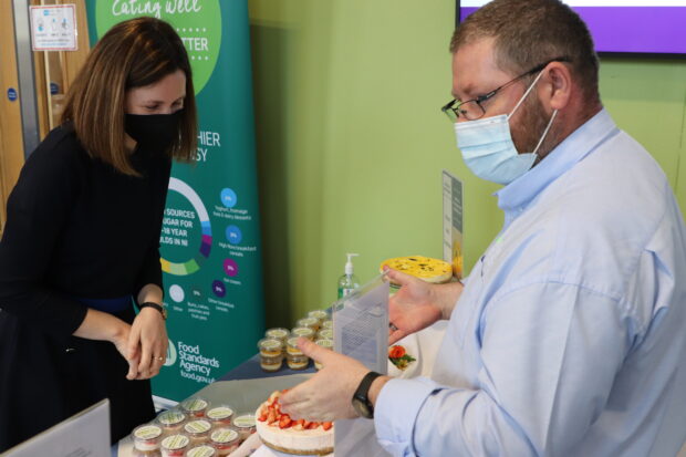 Kathleen Mooney at a stall promoting cheesecake reformulation