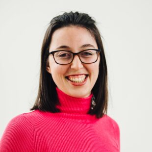 Dr Sophie Hardy, Regulated Products Engagement and Partnership Coordinator, smiling in a pink jumper