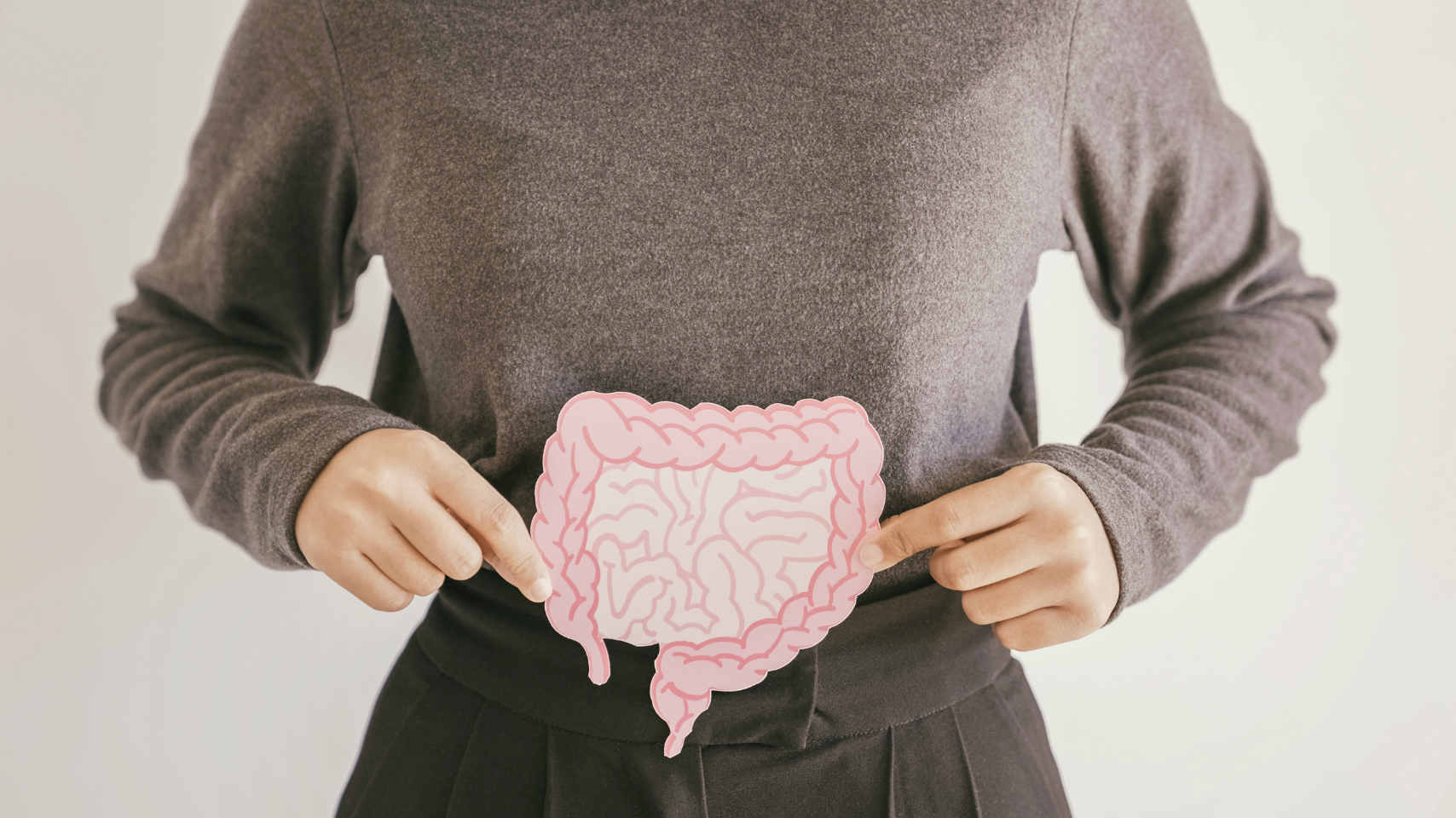 Person holding a paper cutout of intestines